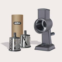 The Zyliss Gourmet Drum Grater Set features a gray base, two interchangeable stainless steel drums, and comes in a branded cylindrical box—an essential tool for any kitchen. 