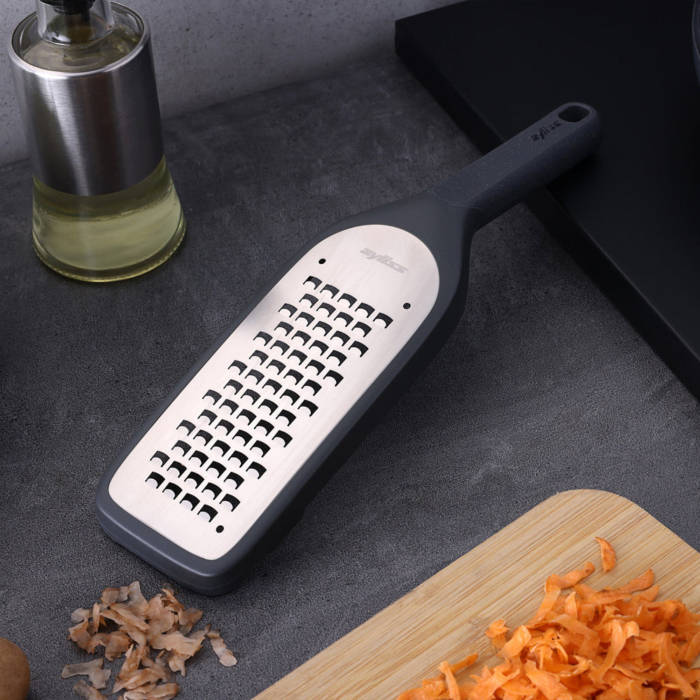 The Zyliss Coarse Grater is a black and silver foot file with a long handle and ultra-sharp grater surface, designed to efficiently remove dead skin from feet.