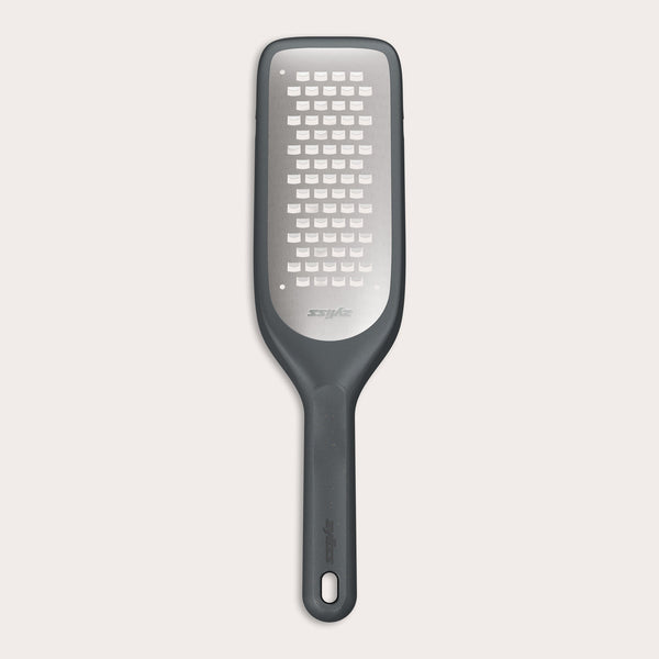 The Zyliss Coarse Grater is a black and silver foot file with a long handle and ultra-sharp grater surface, designed to efficiently remove dead skin from feet.