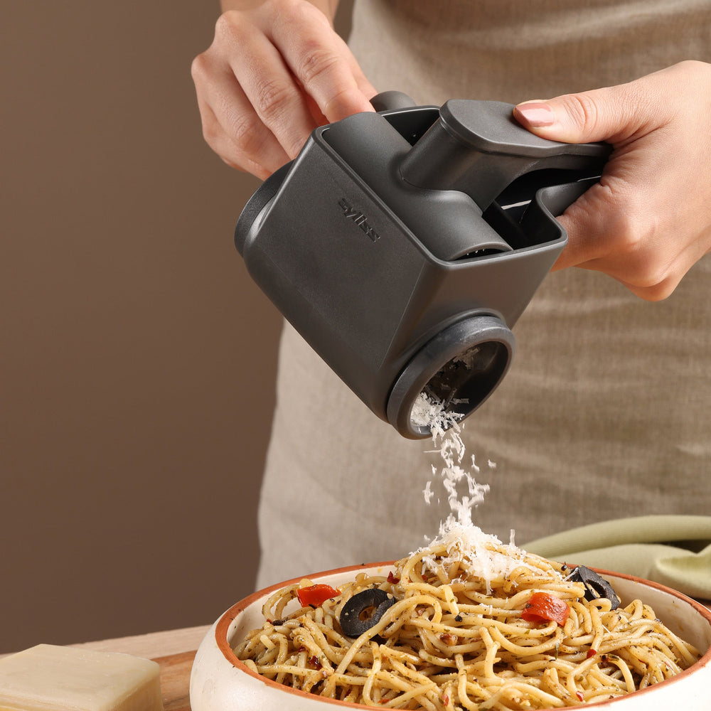 The Zyliss Professional Rotary Cheese Grater is a black, ergonomic kitchen tool with a stainless steel drum and rotating handle for grating or slicing food. Modern and sturdy, it’s dishwasher safe for easy cleaning.