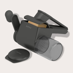 The Zyliss Professional Rotary Cheese Grater Set, in black, features an ergonomic crank, transparent detachable container, and visible grater drum with the handle extended.