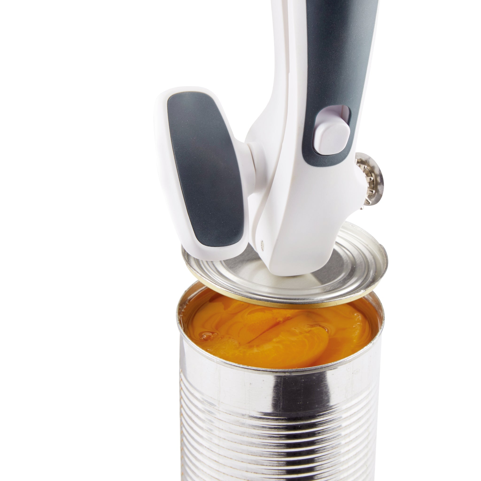 A handheld can opener is opening a metal can filled with sliced peaches in syrup. The can openers blade is cutting through the lid, which is partially lifted. The peaches are visible inside the open can.