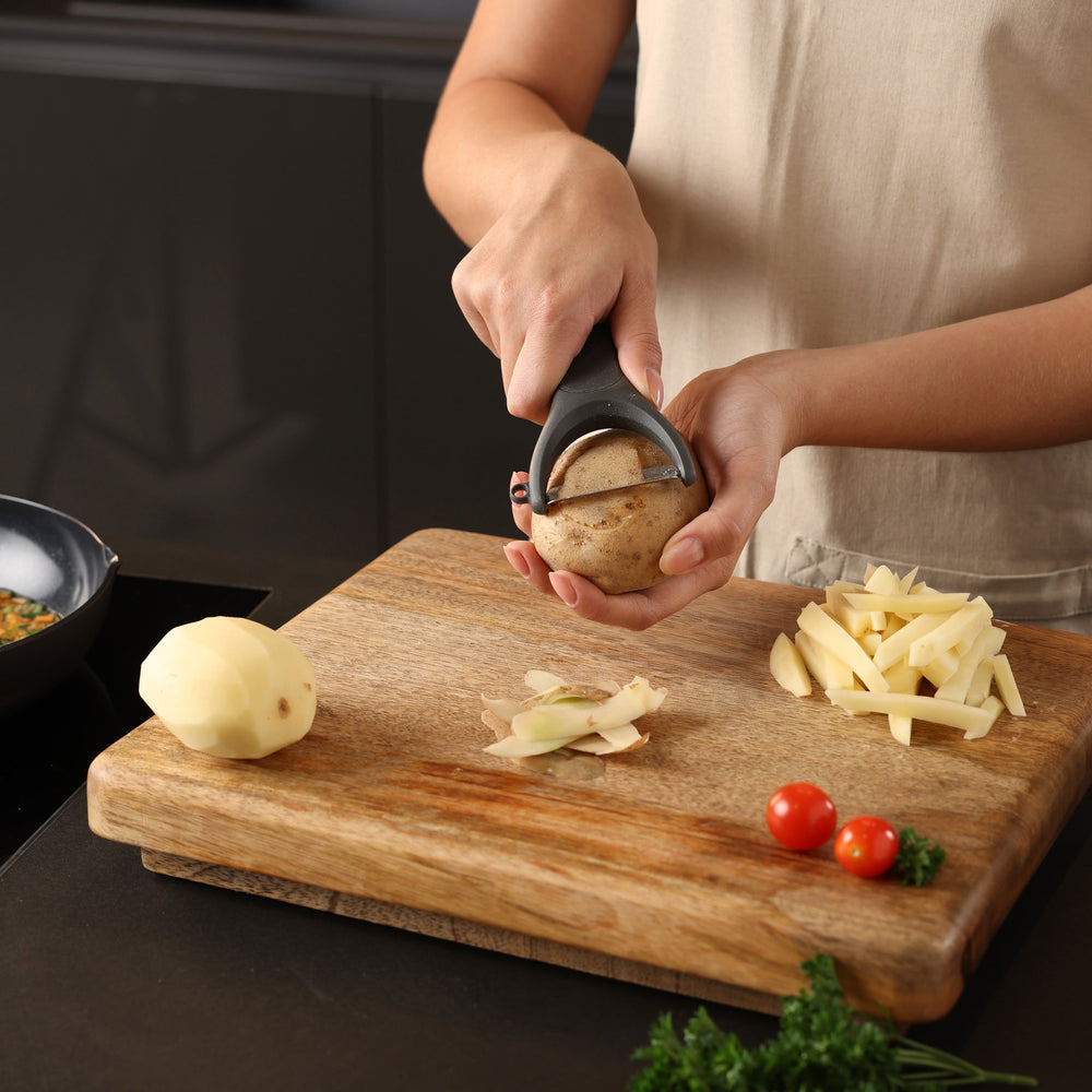 The Zyliss Wide Peeler features a Y-shaped design, ergonomic handle, and horizontal stainless steel blade, shown against a simple light background. 