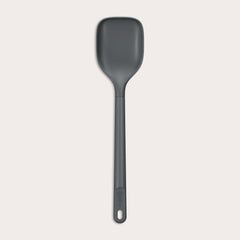 #large A durable Zyliss Spoon in dark gray silicone, featuring a long handle with a hole at the end, displayed on a plain light background. #Large
