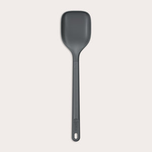 #large A durable Zyliss Spoon in dark gray silicone, featuring a long handle with a hole at the end, displayed on a plain light background. #Large