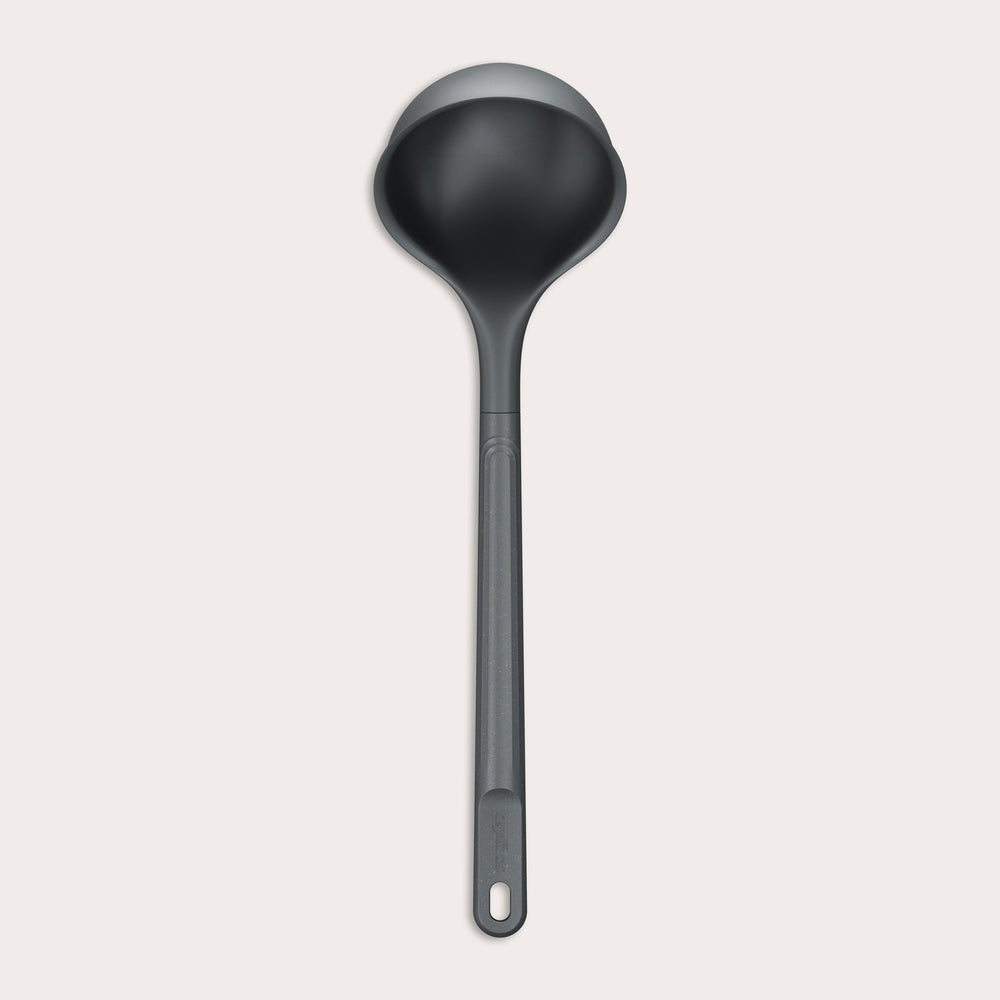 A Zyliss Ladle, black in color with a long handle and deep, rounded bowl for ergonomic use, is shown against a plain light background. #Large