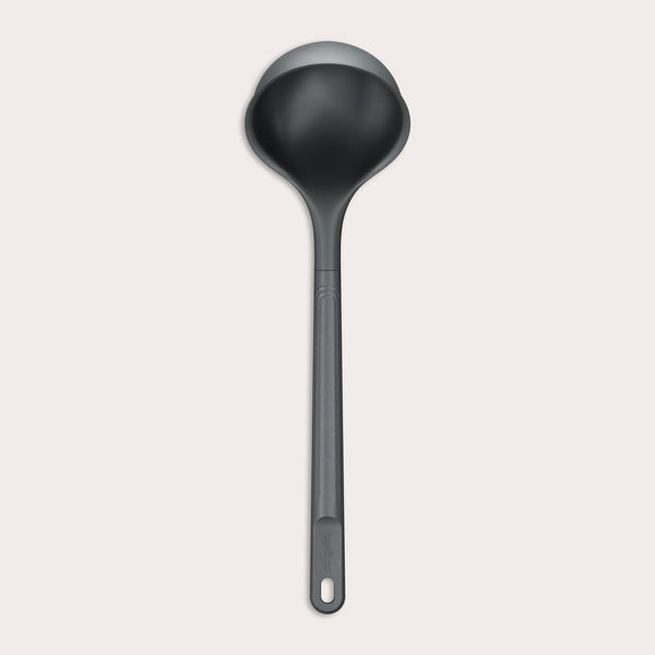 A Zyliss Ladle, black in color with a long handle and deep, rounded bowl for ergonomic use, is shown against a plain light background. #Large