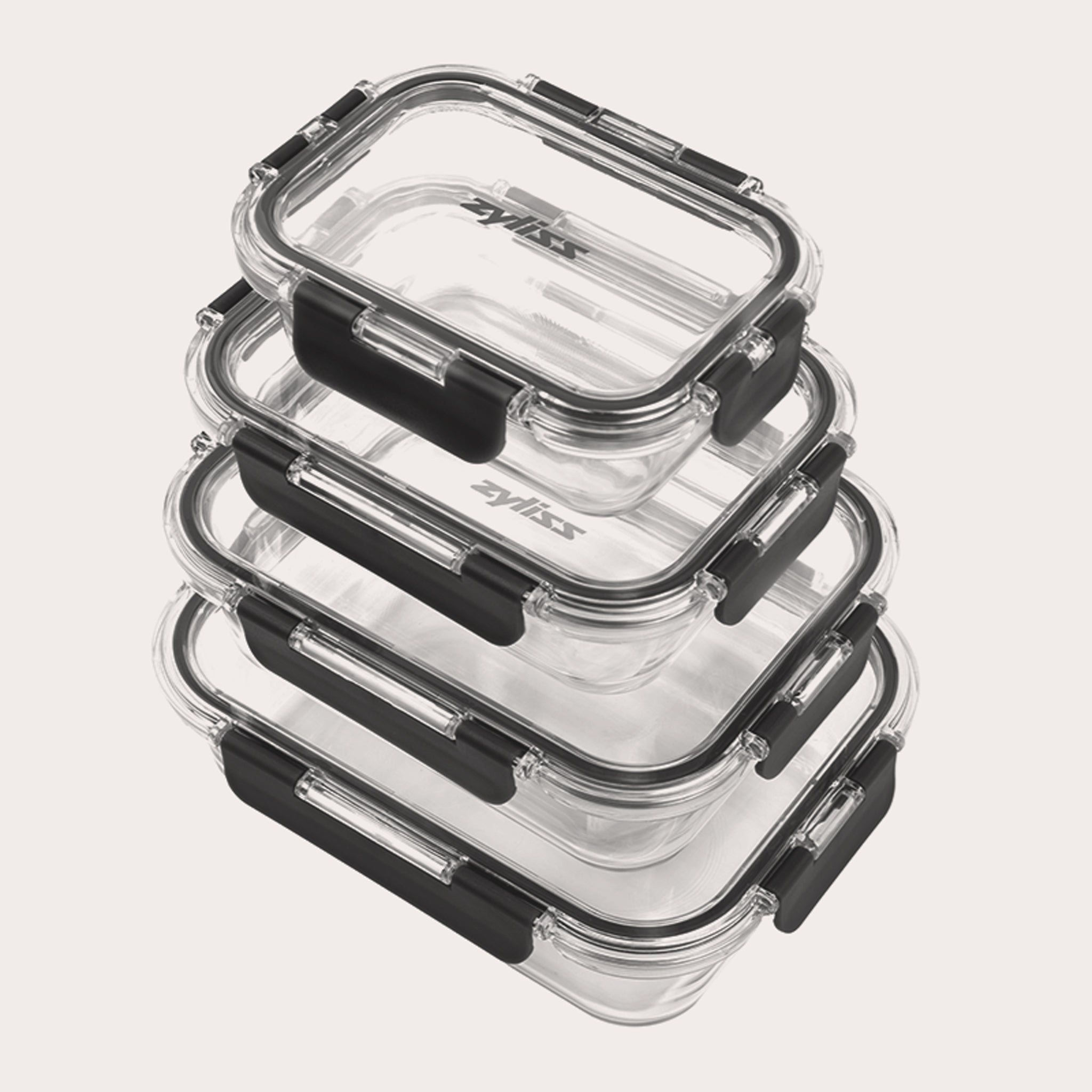 A stack of four clear rectangular glass food containers with black locking lids, arranged neatly on a light background.