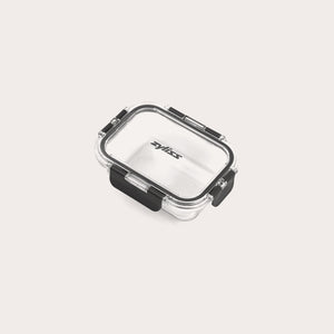 A small, clear rectangular Zyliss Glass Container with a black latch on the front and sides ensures a secure seal. The lid is printed with Zyliss. Shown empty against a white background, its perfect for meal prep. #0.37L/0.39qt
