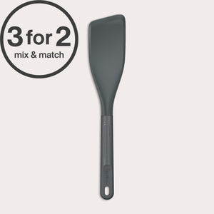 The Zyliss Easy Lift Turner—dark gray, heat-resistant silicone with a slanted edge—is shown on a plain background. Ideal for flipping pancakes on non-stick pans. A “3 for 2 mix & match” circular label appears in the top left corner.